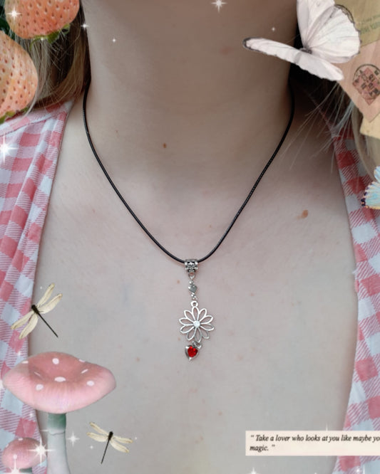 Collier cordon noir avec une fleur et un cœur rouge